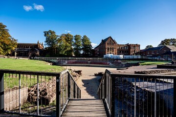 Obraz premium Chester, England, United Kingdom - September 21, 2025 - Downtown Chester in the Cheshire region of England as seen from the area near the city walls and the Roman Ruins. The area features Roman Ruins