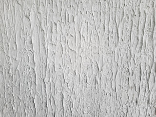 The background of the wall is made of rough white plaster.