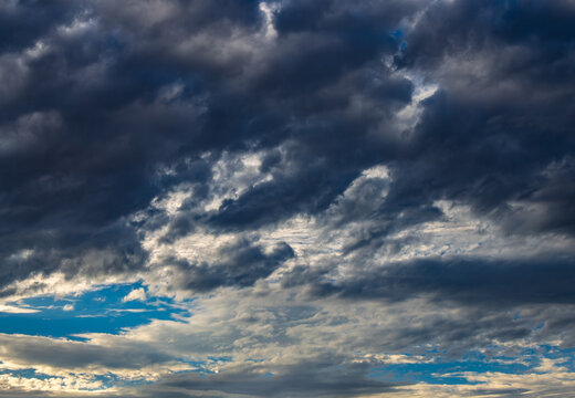 dark storm clouds with a patch of blue sky