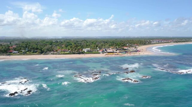 Aerial view of a tropical beach with turquoise water and white sand