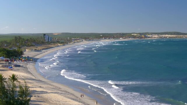 Waves gently roll onto the sandy beach of natal, brazil on a sunny day