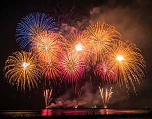 Fireworks display over water at night