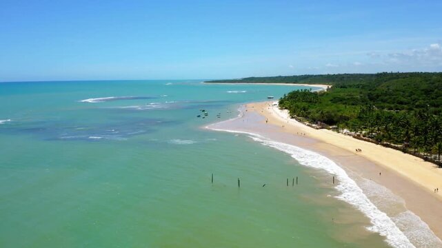 Aerial view of a tropical beach with turquoise water and palm trees
