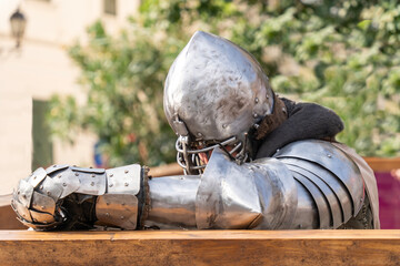 Medieval knight resting in armor at a jousting tournament