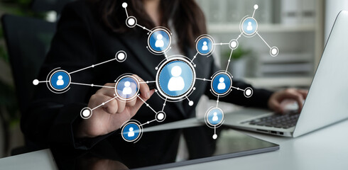 A business professional actively engages with a digital network, illustrating user connections in a contemporary workspace, highlighting collaboration and communication dynamics. Crux