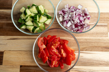 Chopped vegetables in bowls for salad preparation