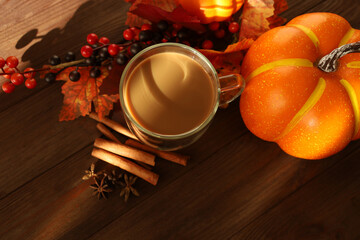 Warm coffee and autumn decorations create a cozy fall ambiance on a wooden table