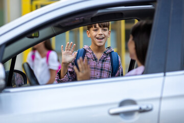 Boy saying bye to mom before entering school ground © Budimir Jevtic