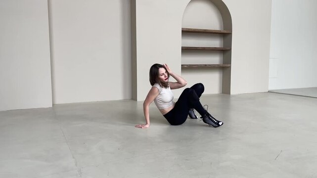 Elegant Woman Dancing in High Heels in Bright Studio