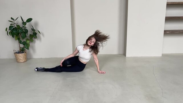 Elegant Woman Dancing in High Heels in Bright Studio