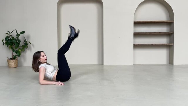 Elegant Woman Dancing in High Heels in Bright Studio