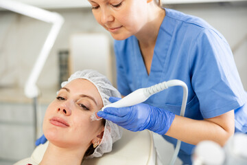Cosmetologist makes facial gas liquid oxygen serum epidermal peeling for rejuvenation girl face...