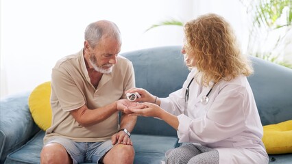 Elderly man receiving medication from caring doctor