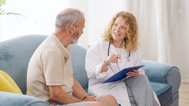 Female doctor explaining diagnosis to senior patient on sofa