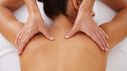 Fototapeta premium Woman receiving a relaxing back massage at a spa, therapist hands giving treatment and therapy for wellness, stress relief, and natural beauty care