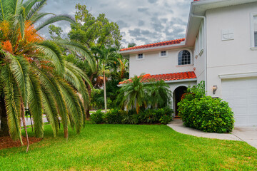Classic Florida real estate with a red-tile roof and landscaped garden.
