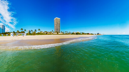 Scenic Ocean Shoreline in Miami, Florida. Palm Trees and Blue Skies