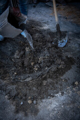 Manual cement mixing with water and shovel
