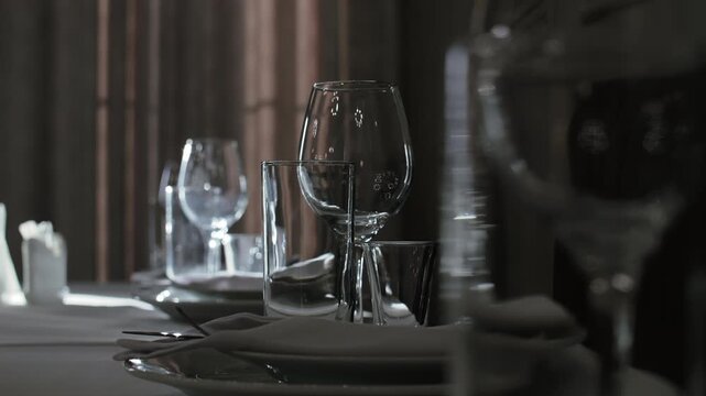Row of elegant table settings with napkins and glassware