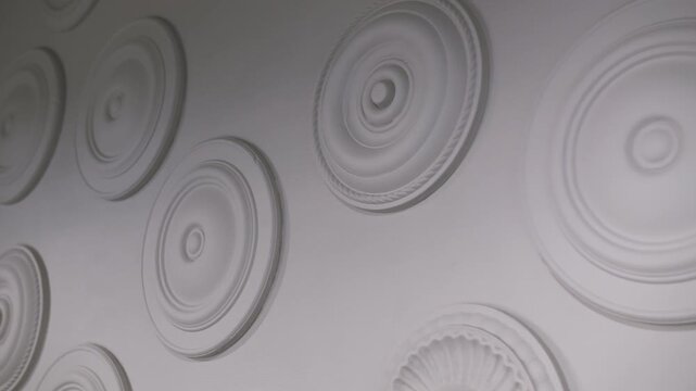 White decorative wall with classic rosettes