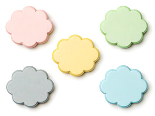 Obraz premium A top down view of five pastel colored cloud shaped objects arranged on a white background surface