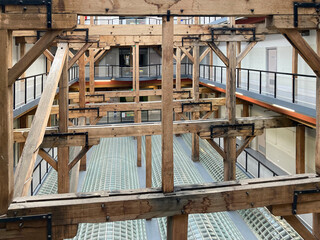 Fototapeta premium Massive historic wooden framework inside a restored former factory