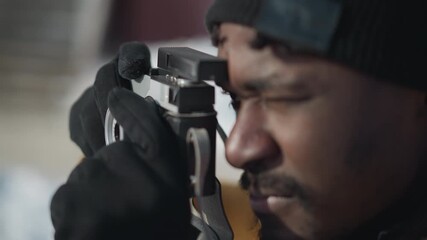 close hands photojournalist gripping digital camera, fine tuning lens settings with gloved fingers, gentle press on shutter button capturing crisp winter street moment under bright sunlight