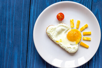 sunshine fried eggs breakfast for kid on blue background