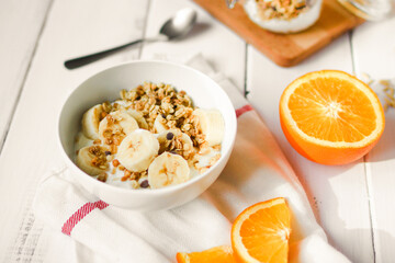 healthy breakfast bowl of yogurt with granola and banana