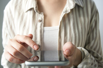 Close-up of woman using mobile phone.