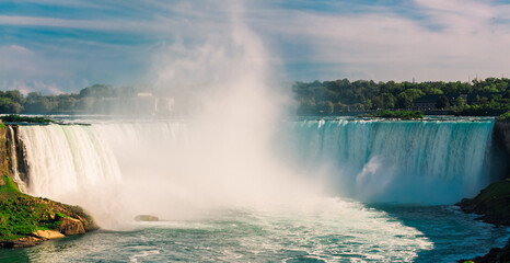 Niagara falls in the summer at sunset time, people in background