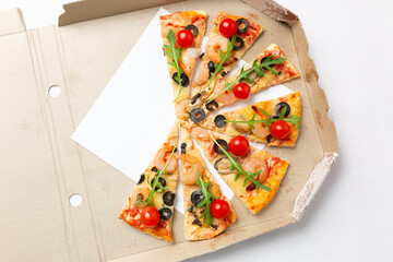 Pizza slices in a cardboard box with shrimp, tomatoes, and olives
