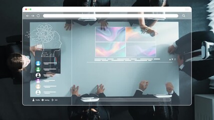 A dynamic overhead view of a business meeting showcasing professionals engaging with digital interfaces displaying data analytics and design concepts in a modern workspace. Raster - Powered by Adobe
