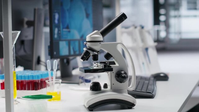 Microscope tool placed on desk in laboratory for scientific experiment, instruments used for genetics research and bioscience within professional facility. Bio sample in lab.