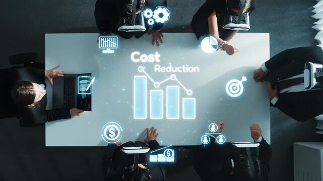Aerial view of a collaborative business meeting focusing on cost reduction strategies, showcasing digital graphs and data analytics for informed decision-making. Raster
