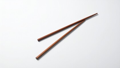 Close-up shot of two wooden chopsticks isolated on a white background, ready to pick up food