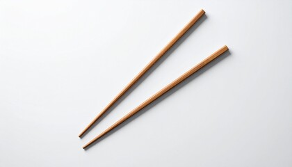 Elegant wooden chopsticks, clean and isolated, diagonally arranged on a pristine white background. Essential tools for Asian cuisine, embodying traditional dining