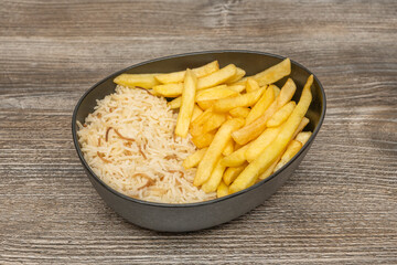 Classic portion of crispy fries accompanying a club sandwich on an oval ceramic plate