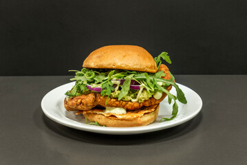 Gourmet burger with a medallion of Sirloin steak, melted Taleggio cheese, pear tomato, and baby lettuce on seeded brioche bread