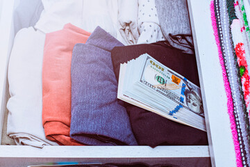 a stash of cash in a closet with underwear kept at home for emergencies