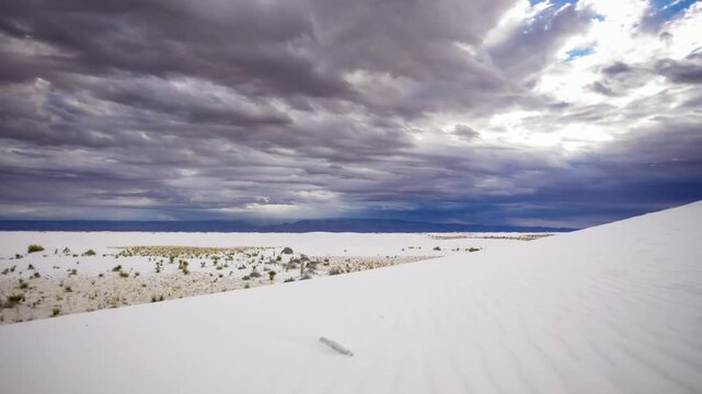 Dramatic clouds hover over the stark white sands of white sands national park