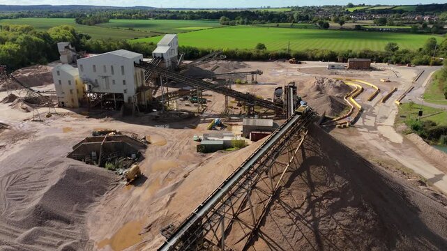 Aerial drone footage of aggregates quarry and industrial conveyors at large mining complex in Nottingham United Kingdom