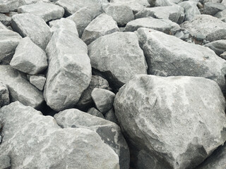 Rock stone boulder gravel texture gray rough natural pile quarry Rugged gray rock texture with rough stone boulder pile, natural gravel surface