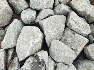 Rock stone gray rough texture natural gravel rubble quarry geology Weathered gray rock texture, rough stone surface with rugged edges