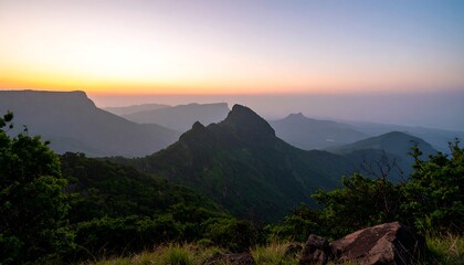 Serene sunrise over misty mountain ranges