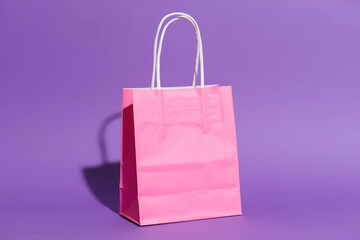 Vibrant pink shopping bag on a bold purple background. Ideal for retail, sales, gifts, e-commerce promotions, or design with ample copy space. Clean, modern look.