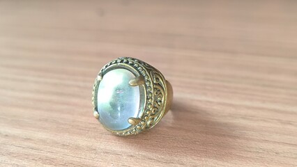 Elegant statement ring with iridescent stone and vintage-inspired band offers a touch of old-world glamour and whimsical charm for any occasion