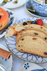 Homemade Multi grain sourdough bread with flax seeds, strawberry and blueberry on luxury plate. Healthy Breakfast table setting under sunlight.
