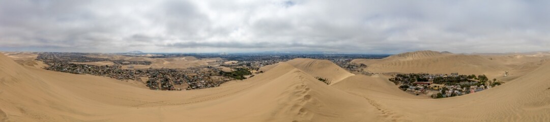 Oasis Huacachina high resolution wide angle panoramic landscape. Sand dunes dry desert in Peru....