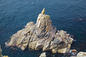 Irish Lady Rock, the granite rocky outcrop in the sea at Sennen Cove. Cornwall. England. UK
